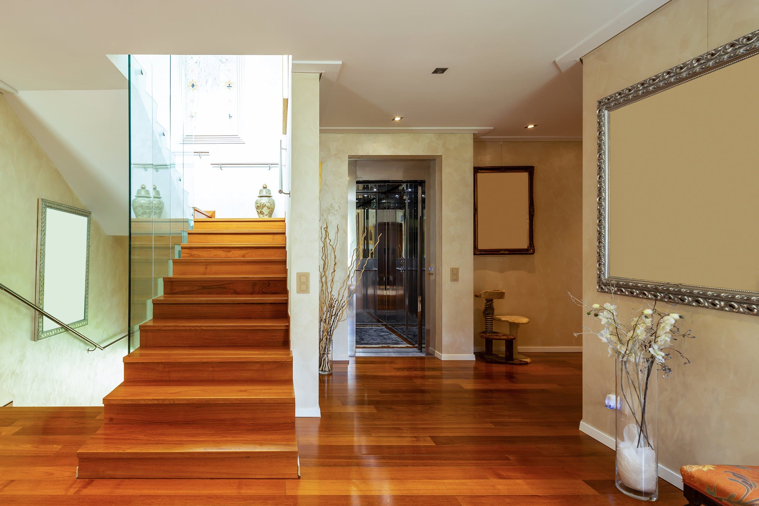 Modern residential elevator with glass doors in a luxury Colorado home interior