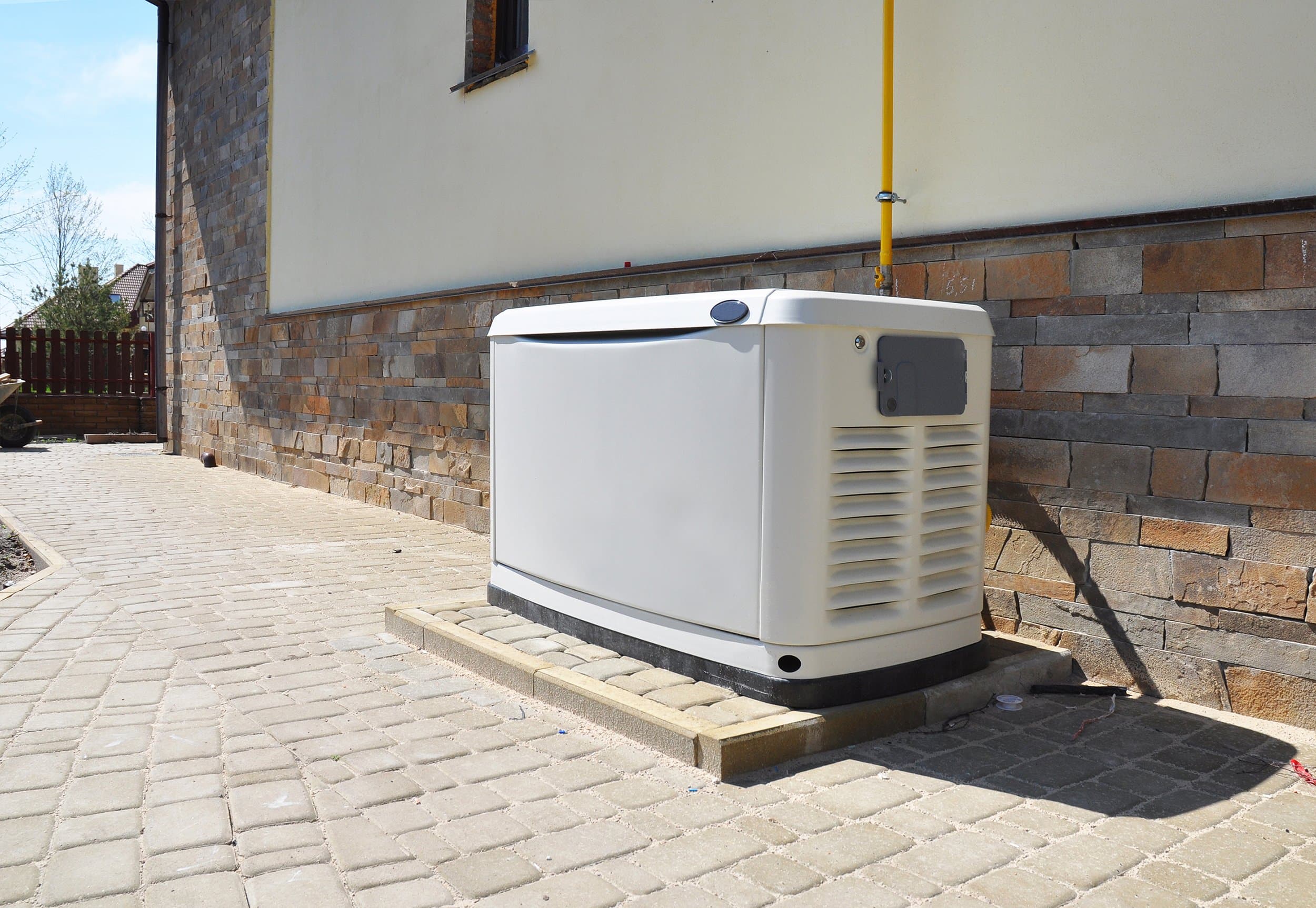 Standby whole house generator installed beside a luxury Colorado home, providing backup power