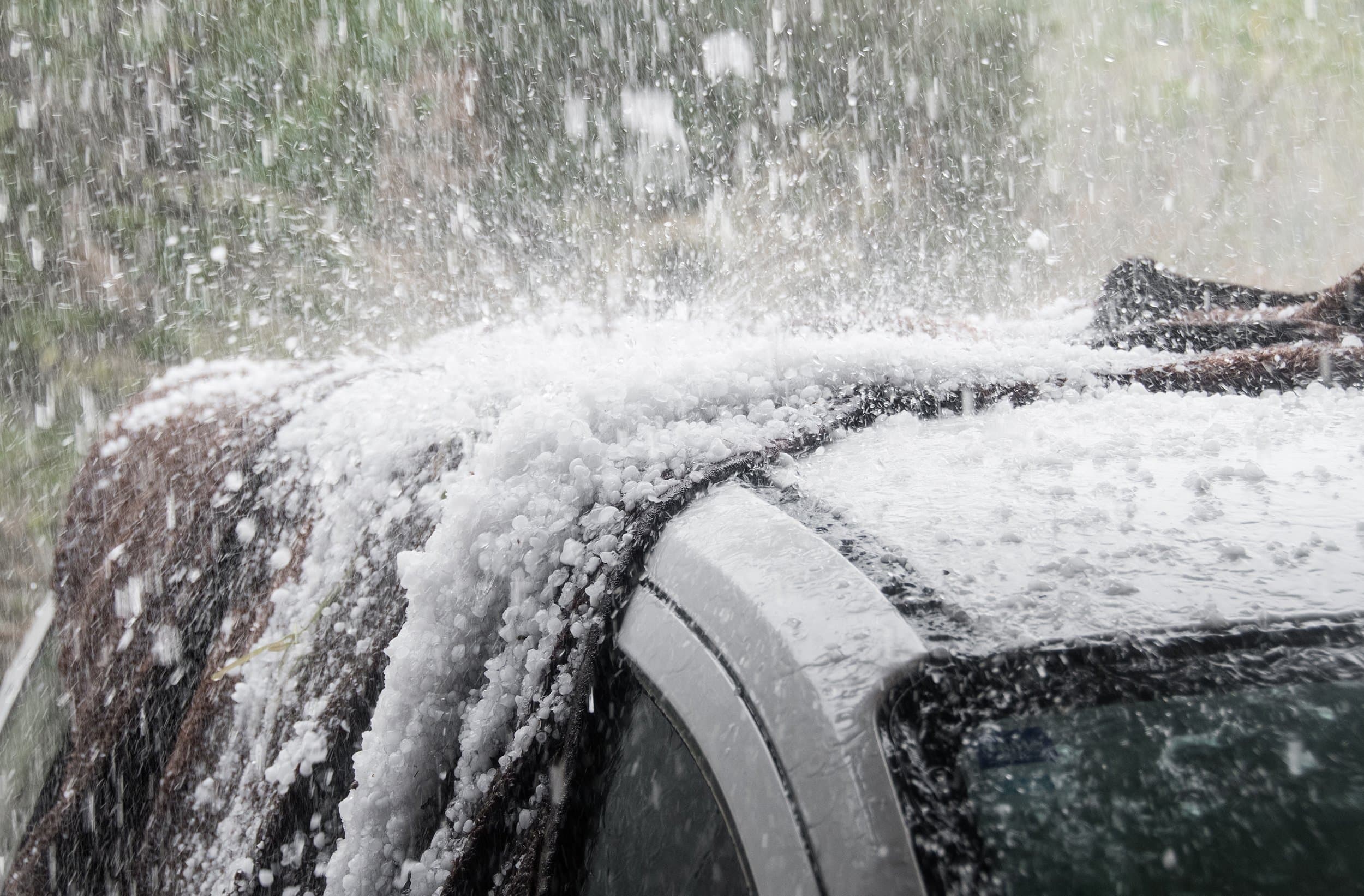 Large hailstones scattered on the ground beside a Colorado home after a severe hailstorm