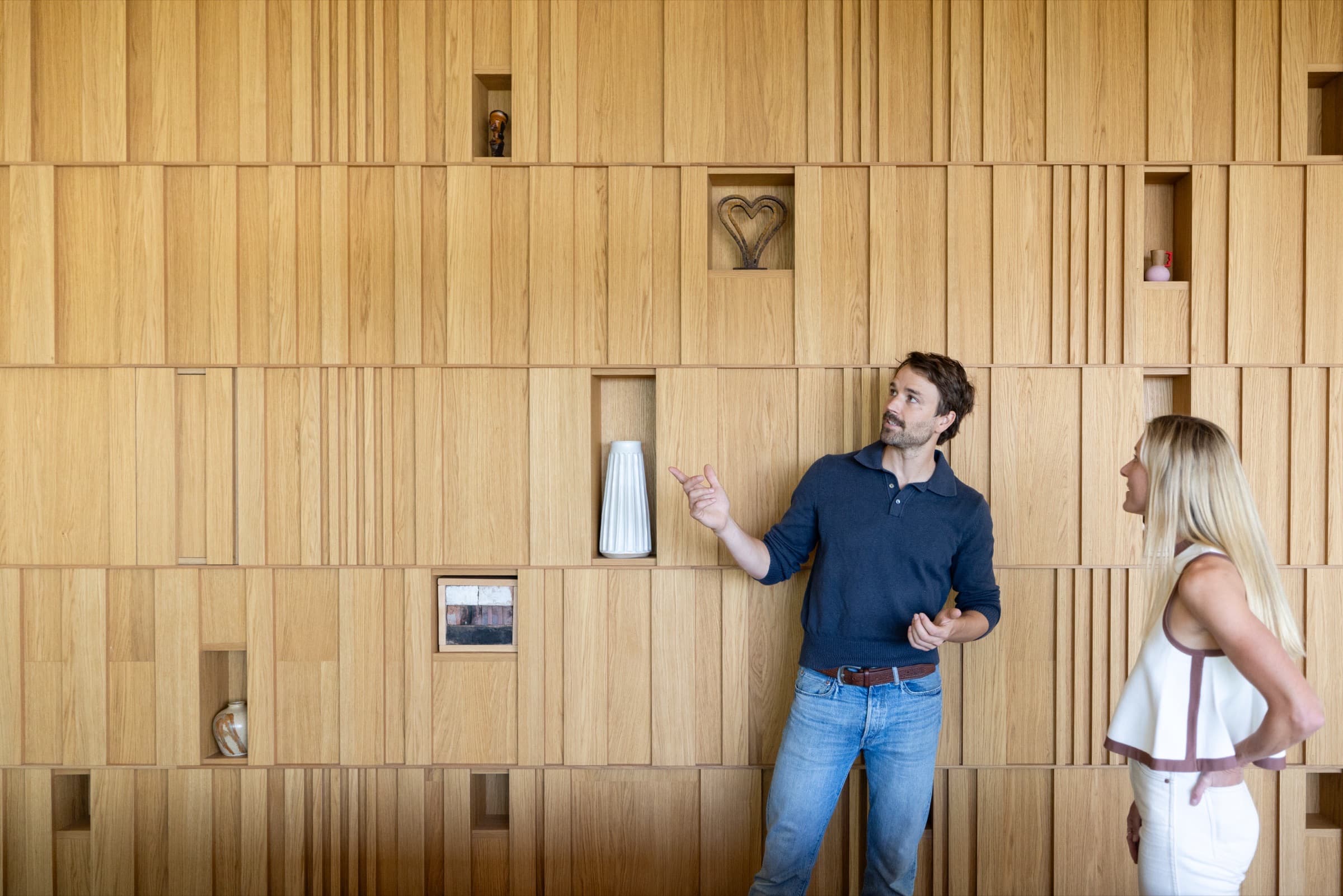 A Willow concierge walking a homeowner through her custom oak-paneled living space