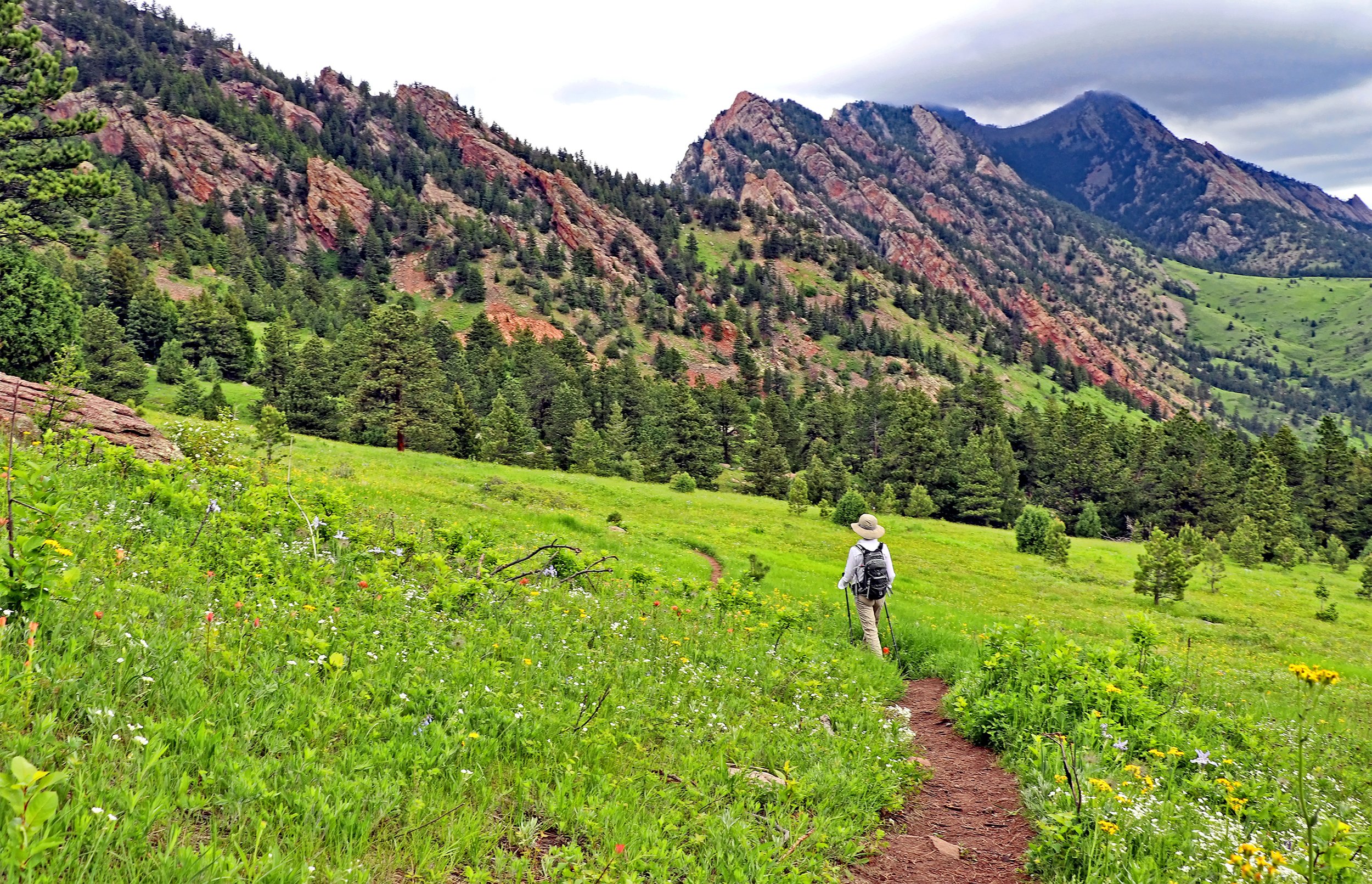  A woman hikes the Goshawk Ridge trail in Boulder. Looking for lesser known or hidden gem trails in Boulder? Check out our Ultitmate Guide to Boulder Hikes and discover your next favorite hiking trail.  